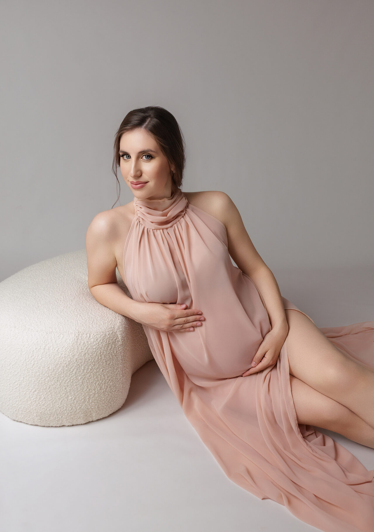 Pregnant woman wearing a timeless white maternity dress