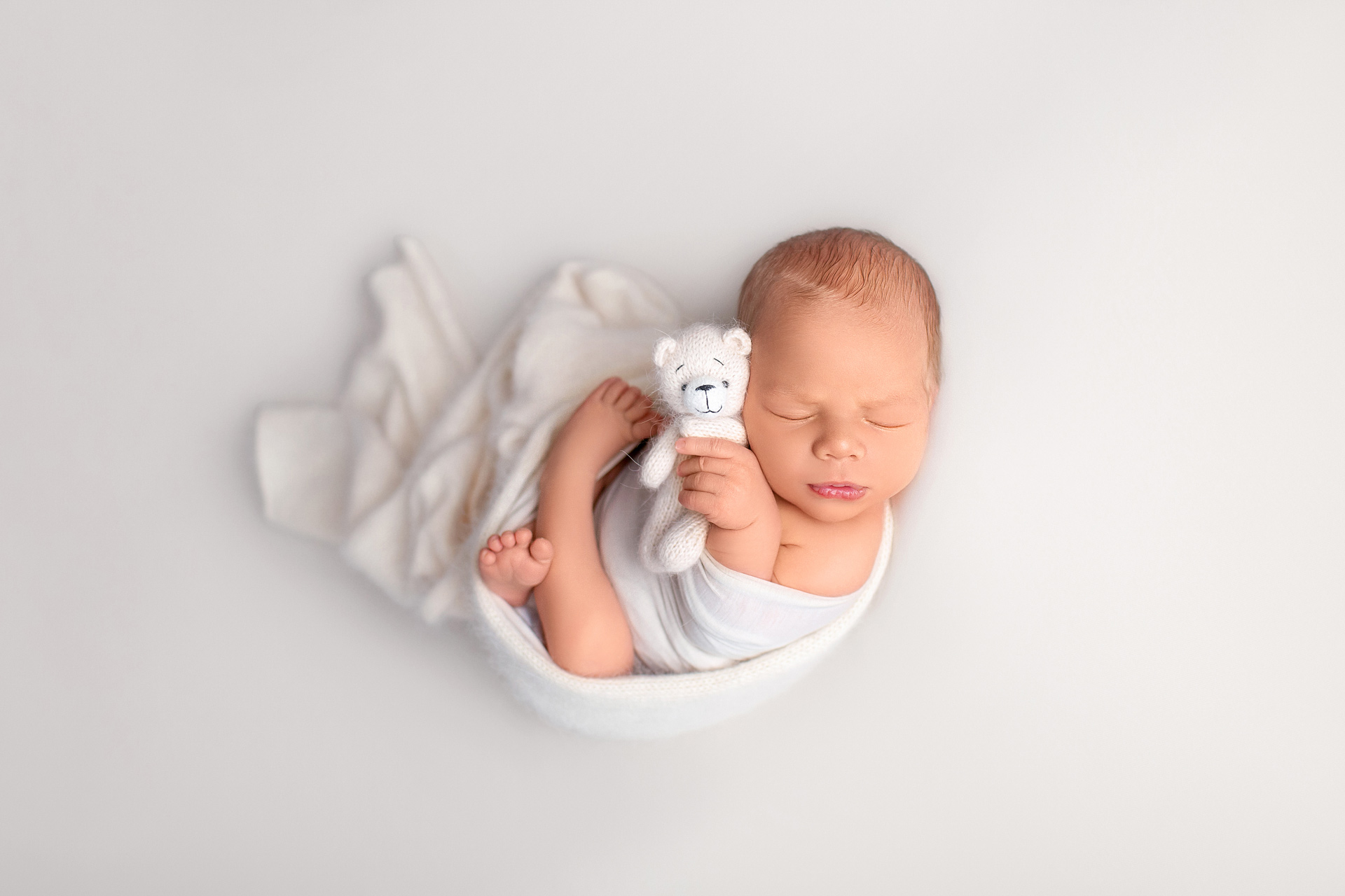 Newborn-baby-peacefully-sleeping-in-a-neutral-studio-setup