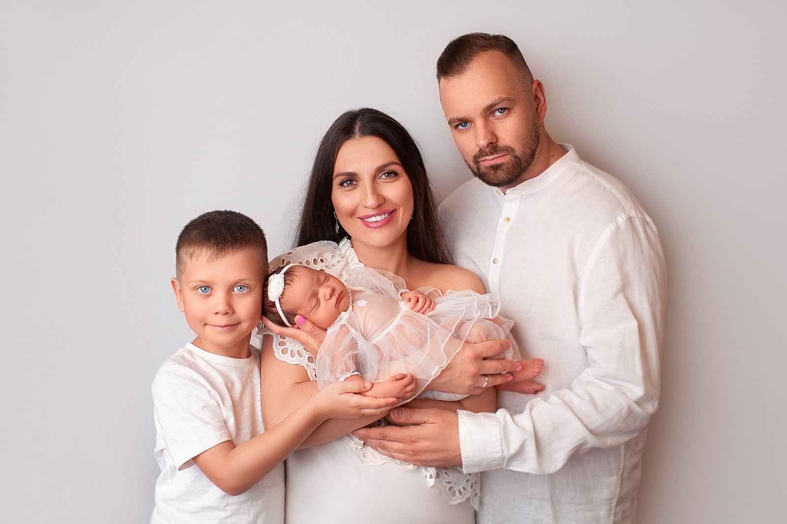 mother holding newborn baby during photoshoot